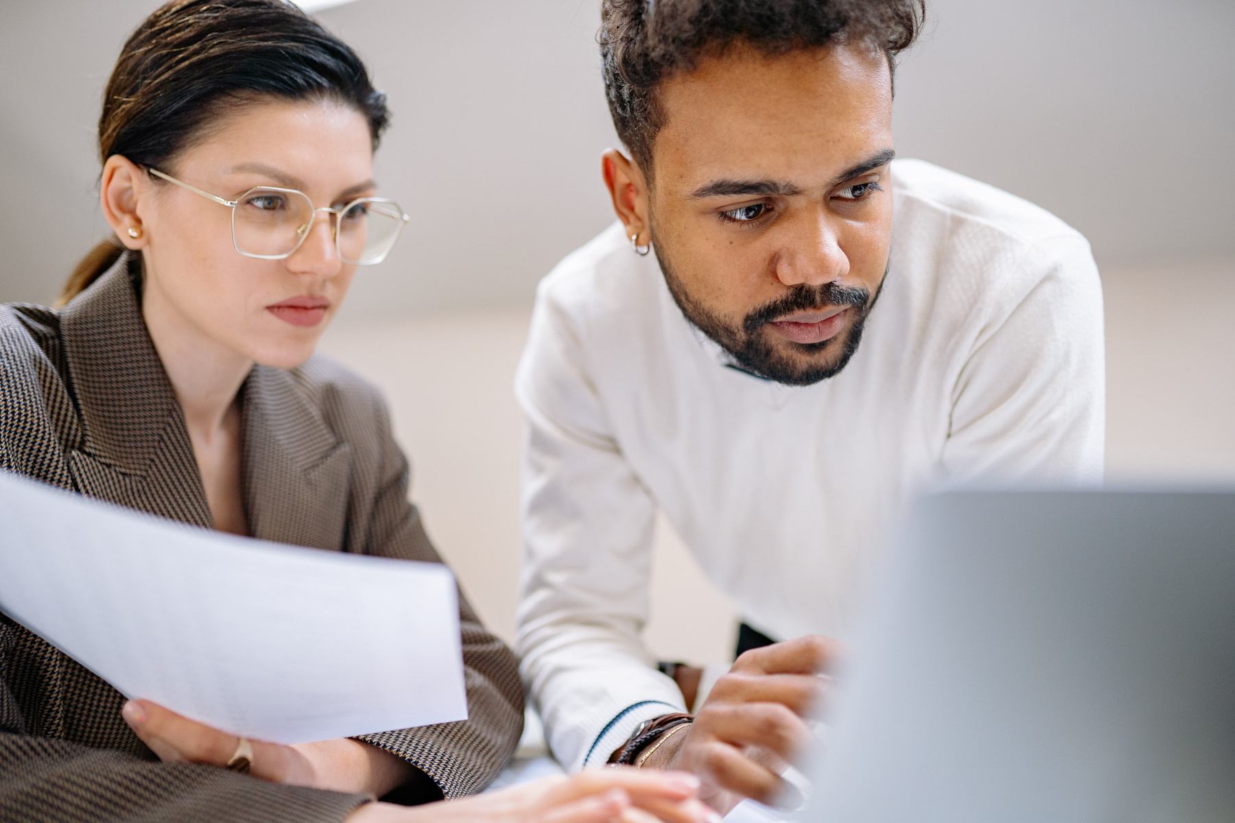 Man and Woman Looking at the Laptop