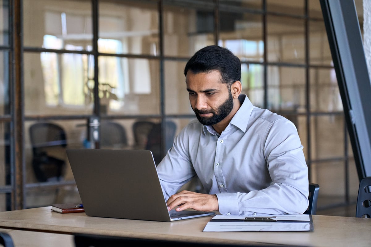 Male Professional Working with Laptop in Office