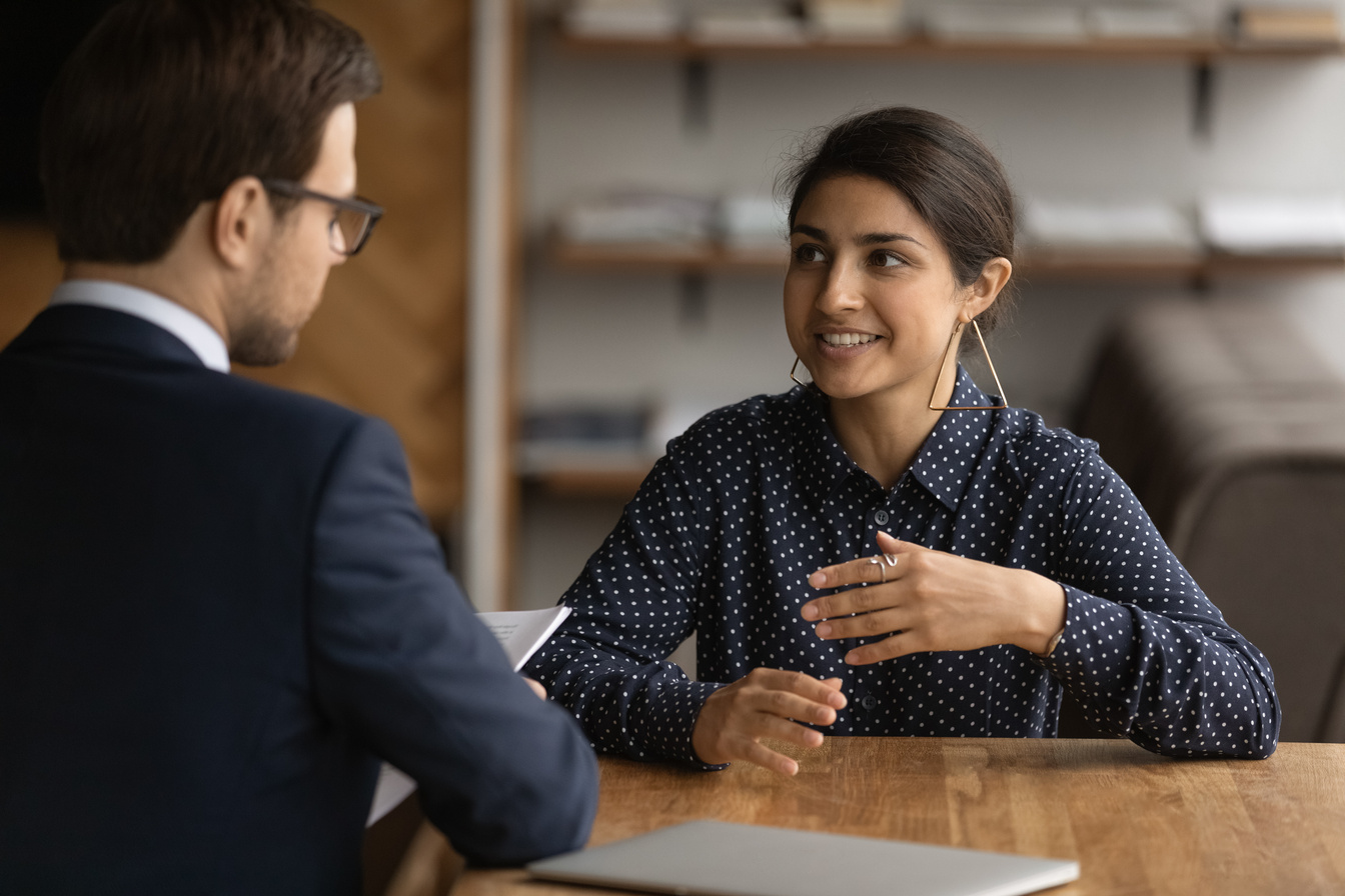 Confident Indian woman talk with employer at interview